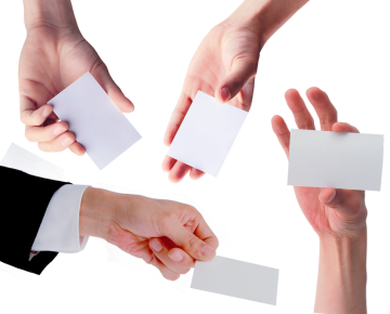 2 ladies' hand and 2 mens' hands holding business cards out to each other