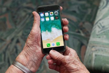 elderly female hands holding an iphone showing the desktop wallpaper