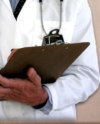 man in a white doctor's coat holding a clipboard and writing down something